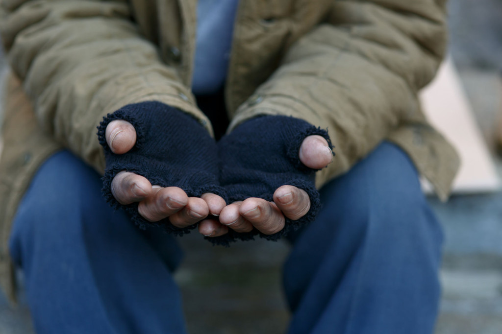 49965926 - man in need. unhappy homeless man is holding hands to get help.